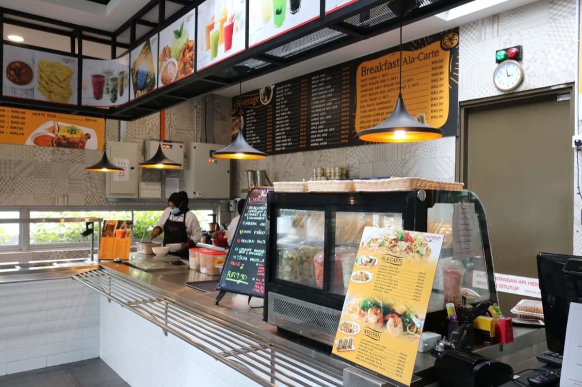 Modern corporate cafeteria with diverse food stations